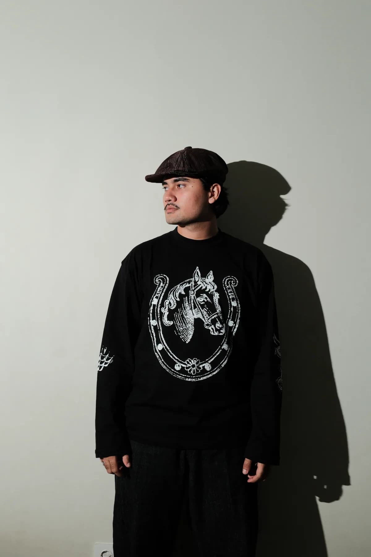 Model wearing the black Horseshoe graphic long sleeve.